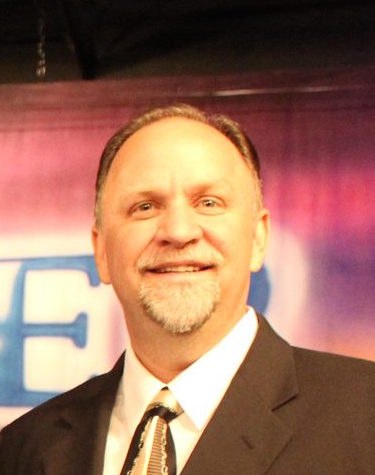 Head and shoulders portrait of Bishop Dr. Jeffrey W. Larson in a suit.