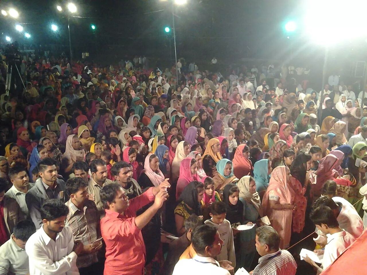 A large crowd gathered at night during a ministry visit in India.