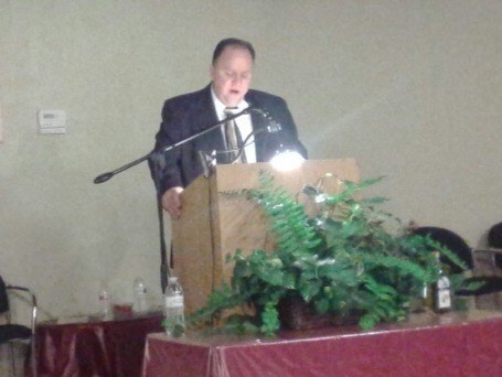 Bishop Dr. Jeffrey W. Larson speaking at a podium.